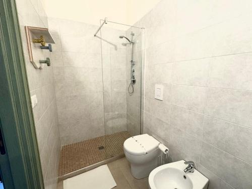 a bathroom with a shower and a toilet and a sink at Loft IL FICO in Zapponeta
