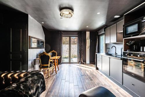 a living room with a couch and a table at Espaces Gîtes in Sainte-Escobille