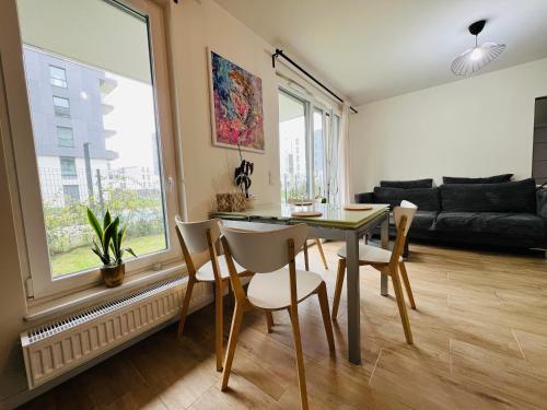 a living room with a table and chairs and a couch at ByTheSea Apartment in Gdańsk