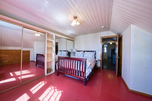 a bedroom with a bed and a red floor at Josephine in Leadville