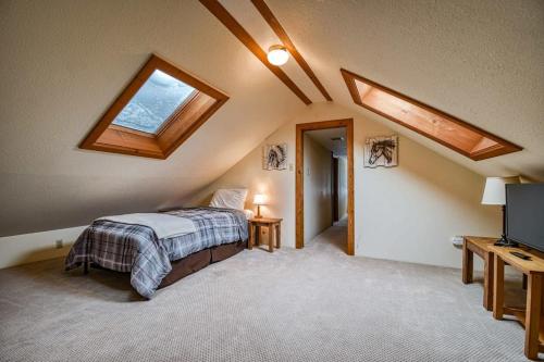 a bedroom with a bed and a skylight at Hen House A Cozy Victorian Escape in Leadville