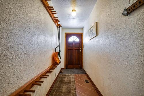 a hallway with a wooden door and stairs at Hen House A Cozy Victorian Escape in Leadville