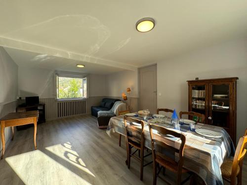 a living room with a table and a couch at Les Hauteurs de Lugrin - Maison de Vacances in Lugrin