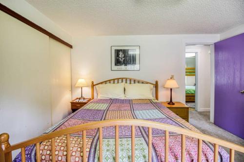 a bedroom with a large bed with purple walls at Mountain Bluebell Cabin in Leadville