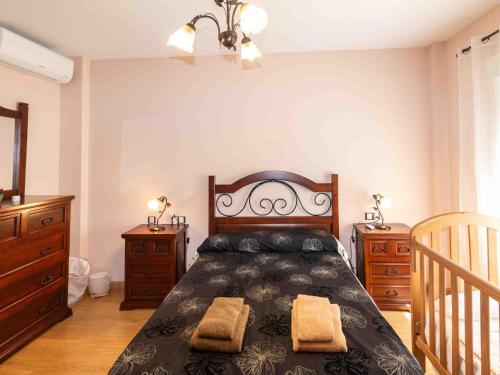 a bedroom with a bed with two dressers and a bed sidx sidx sidx sidx at Casa rosa del romeral in Nigüelas
