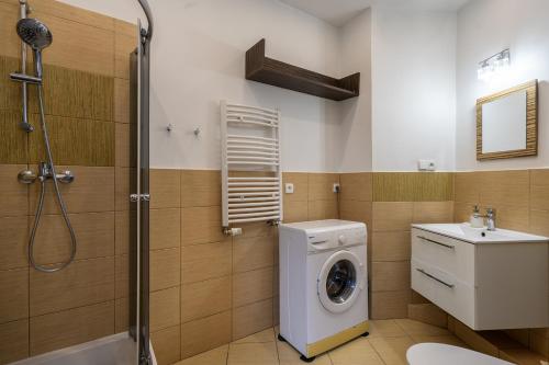 a bathroom with a washing machine and a sink at 32 Gdynia Oksywie - Apartament Mieszkanie dla 4 os in Gdynia