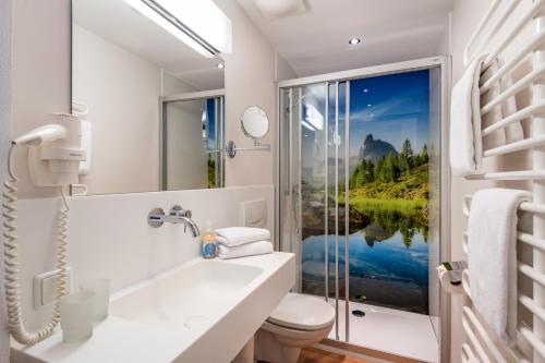 a bathroom with a view of a lake at Appartements Herold in Söll