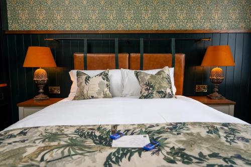 a bedroom with a large bed with two lamps at Himley House by Chef & Brewer Collection in Himley