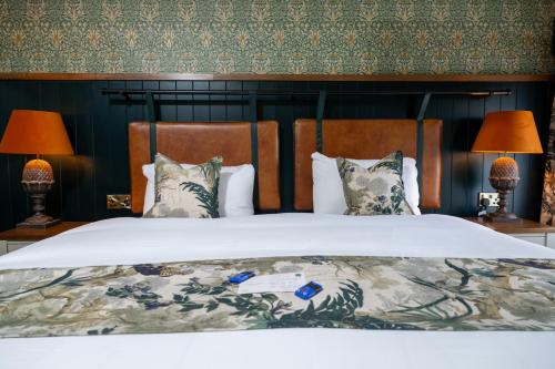 a bedroom with a large bed with two lamps at Himley House by Chef & Brewer Collection in Himley