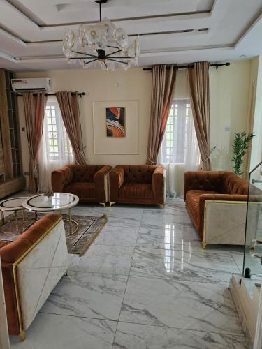 a living room with couches and a table at MDCUBE HOMES AND PROPERTIES in Ibadan