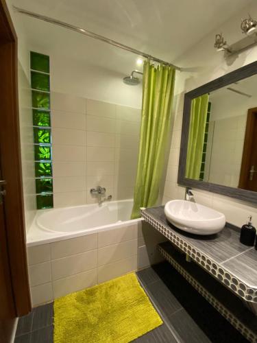 a bathroom with a tub and a sink and a mirror at Apartament Mosiężna & Taras & Free Parking & Self Check in 24H in Wrocław
