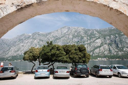 a bunch of cars parked in front of a mountain at Galathea House in Kotor