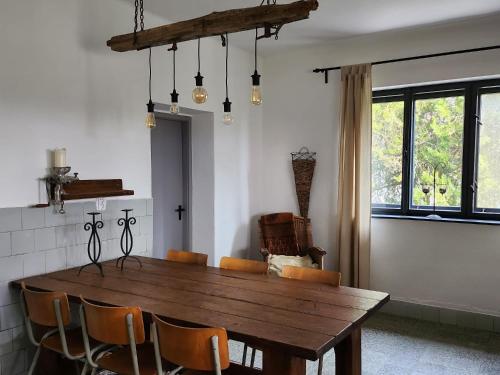 a dining room with a wooden table and chairs at Moongardenhouse in Kováčovce
