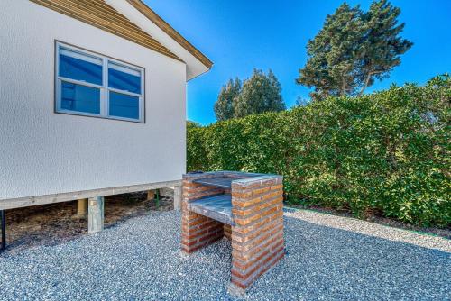 a brick bench sitting outside of a house at POR ELIMINAR Pacific Cabin 2B W Wifi Smart TV & Parking in Algarrobo