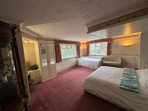 a bedroom with a bed and a chair in it at Maylands - -Where memories are made. in Stanford-le-Hope