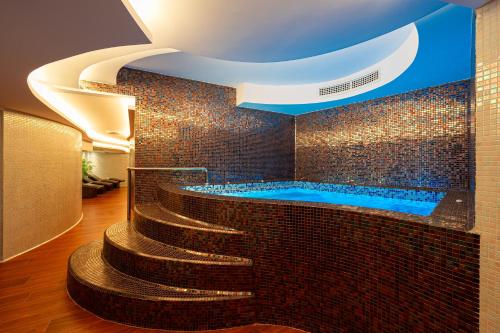 a bathroom with a jacuzzi tub and a staircase at Hotel De‘Andros Virpazar in Bar