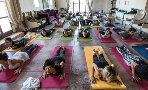 a group of people doing yoga in a room at Azienda Agricola Mandranova in Palma di Montechiaro