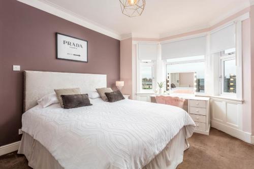 a bedroom with a white bed and a window at 67 Midton Road in Prestwick