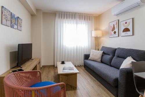 a living room with a couch and a tv at Vigo Bay Apartments by Olala Homes in Vigo