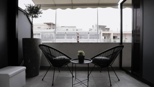 a small table and two chairs on a balcony at Mini luxury suites by Sea&theCity in Thessaloniki