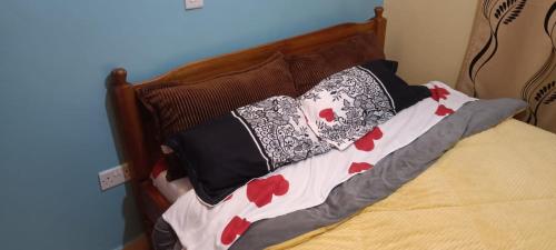a bed with pillows on it in a bedroom at Room in Kamakis Behind Greenspot opp 1 7 lounge in Ruiru