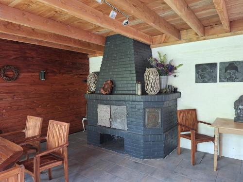 a fireplace in a living room with a table and chairs at B&B Dersum Dream in Dersum