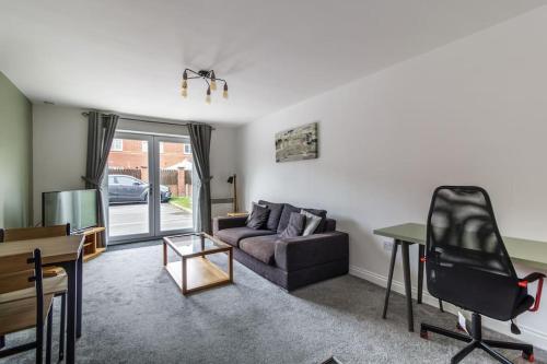 a living room with a couch and a table at 2 Bedroom Flat 1, Glasshoughton in Castleford