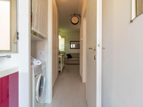 a hallway leading to a laundry room with a washer and dryer at Lovely Home Apartment in Lecco
