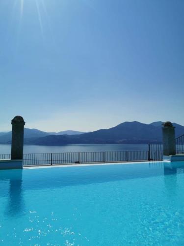 a large swimming pool with a view of the water at Residence Il Vigneto in Oggebbio
