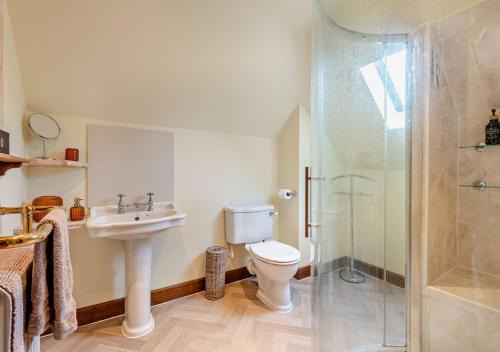 a bathroom with a toilet and a shower and a sink at Throop House Cottage - Bournemouth in Bournemouth