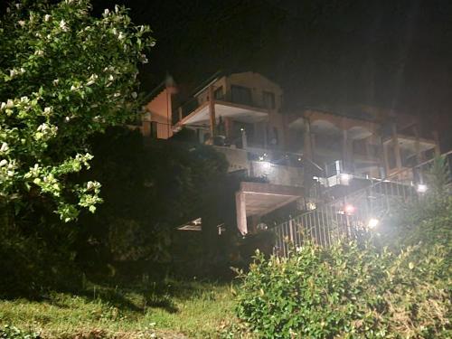 a house sitting on top of a bridge at night at Residence Il Vigneto in Oggebbio