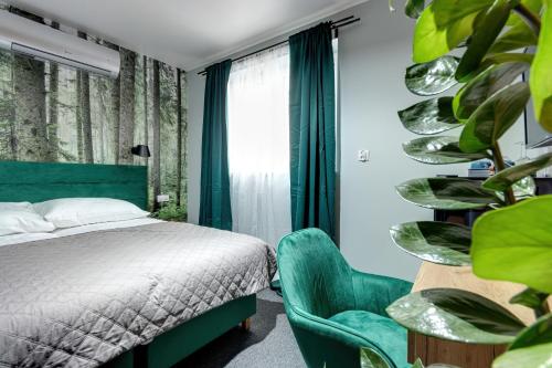 1 dormitorio con 1 cama y 1 silla verde en Villa Noce i Dnie, en Radziechowy