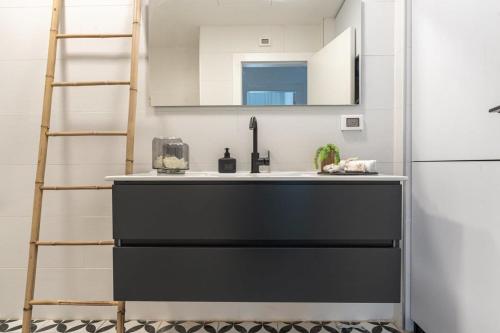 a kitchen with a sink and a refrigerator at Deluxe 1 Bedrooms Apartment Terrace in City Center in Jerusalem