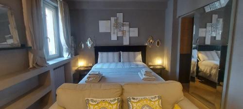 a bedroom with a bed and two chairs in it at Gondola Azzurra in Civitanova Marche