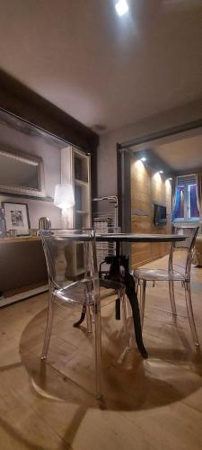 a glass table and two chairs in a room at Gondola Azzurra in Civitanova Marche
