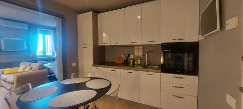 a kitchen with a table and a kitchen with white cabinets at Gondola Azzurra in Civitanova Marche