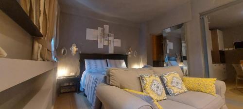 a living room with a bed and a couch at Gondola Azzurra in Civitanova Marche