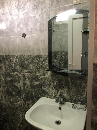 a bathroom with a sink and a mirror at Cottage Gio in Kobuleti