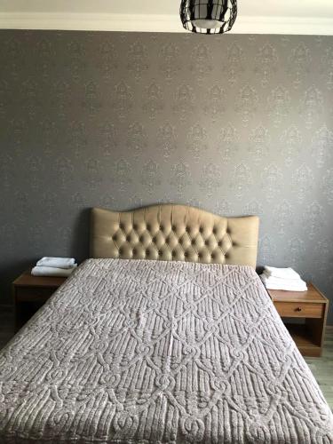 a bedroom with a bed and two night stands at Cottage Gio in Kobuleti