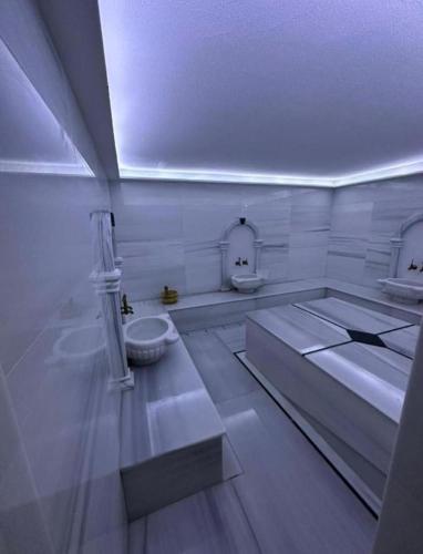 a white room with two sinks and a toilet at Sea view Penthouse ABELIA 12 floors iskele Cyprus in Iskele