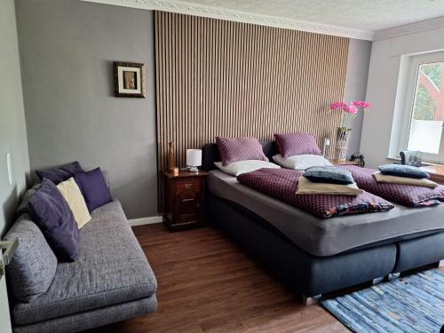 a bedroom with a bed and a couch at B&B Dersum Dream in Dersum
