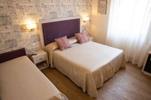 Postel nebo postele na pokoji v ubytování Hotel Pardini