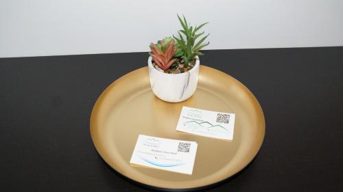 a yellow plate with a potted plant on a table at High End Velden am Wörthersee in Velden am Wörthersee