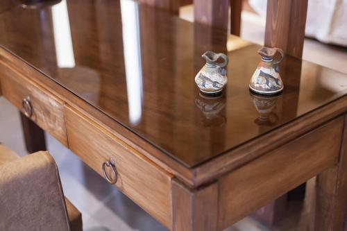 a wooden table with two vases on top of it at Utopia Luxury Suites - Old Town in Rhodes Town
