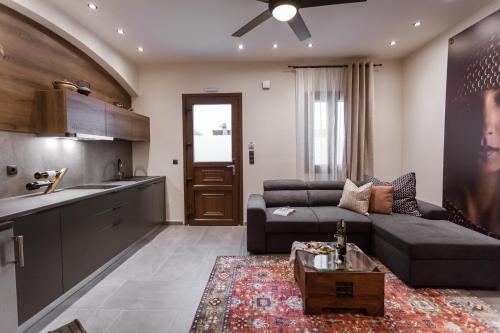 a living room with a couch and a table at Utopia Luxury Suites - Old Town in Rhodes Town