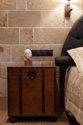 a nightstand with a skull on it next to a bed at Utopia Luxury Suites - Old Town in Rhodes Town