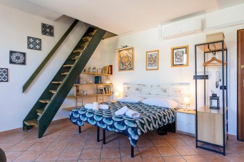 a bedroom with a bed and a staircase at Casa Ginevra - 3 Minutes Walk from the Sea in Livorno