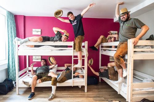 a group of people standing on bunk beds at Wombat's City Hostel Munich Hauptbahnhof in Munich