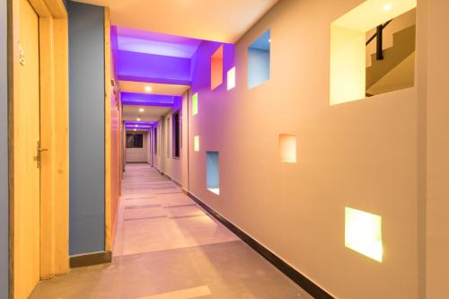 a corridor in a building with purple lights on the walls at Sunshine Resort Pokhara - Your Private Paradise in Pokhara