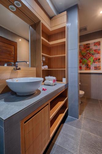 a bathroom with a bowl sink on a counter at Matahari Tulamben Resort, Dive & SPA in Tulamben